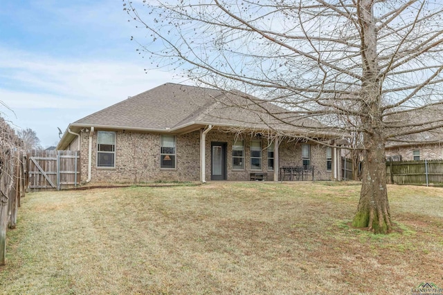 back of house featuring a yard