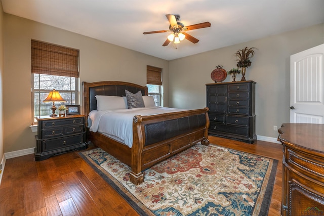 bedroom with multiple windows, dark wood-type flooring, and ceiling fan