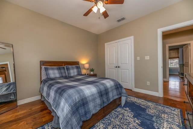 bedroom featuring ceiling fan, dark hardwood / wood-style flooring, and a closet