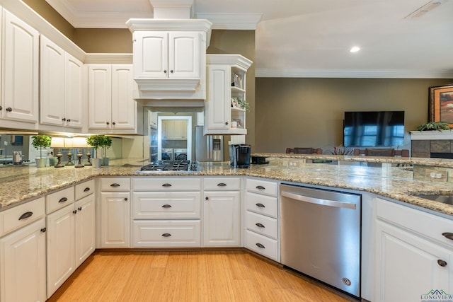 kitchen with white cabinetry, light stone counters, light wood-type flooring, ornamental molding, and appliances with stainless steel finishes