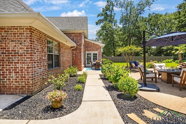 909 University Dr, Carthage, TX 75633 - view of patio with a fire pit and french doors