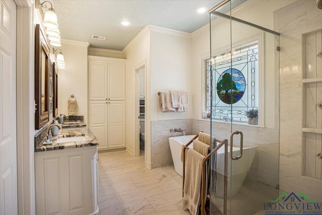 909 University Dr, Carthage, TX 75633 - full bath with double vanity, marble finish flooring, a freestanding tub, crown molding, and a shower stall