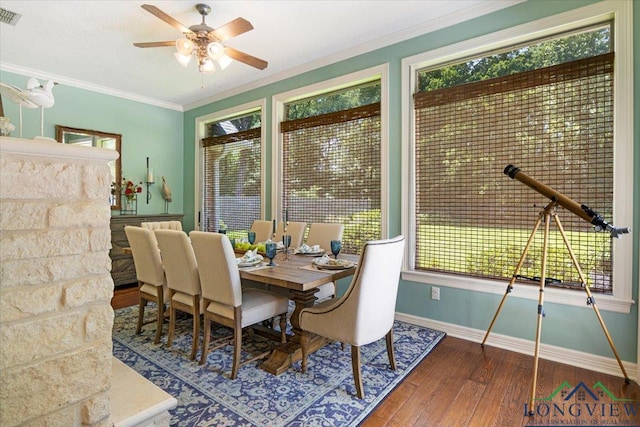 909 University Dr, Carthage, TX 75633 - dining space featuring wood-type flooring, baseboards, a ceiling fan, healthy amount of natural light, and ornamental molding