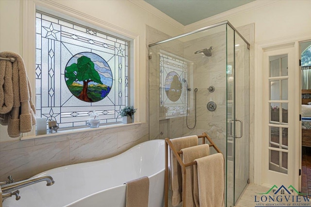 909 University Dr, Carthage, TX 75633 - bathroom featuring a freestanding tub, ornamental molding, and a shower stall
