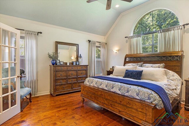 909 University Dr, Carthage, TX 75633 - bedroom featuring lofted ceiling, crown molding, multiple windows, wood-type flooring, and baseboards