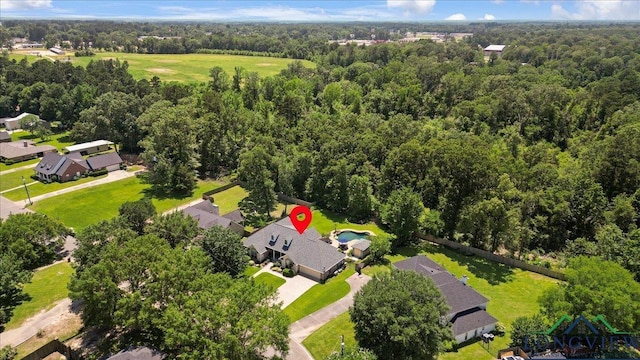 909 University Dr, Carthage, TX 75633 - aerial view of residential area featuring a heavily wooded area