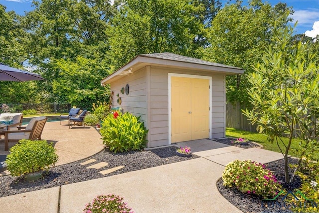 909 University Dr, Carthage, TX 75633 - view of shed featuring a fenced backyard