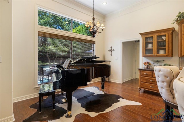 909 University Dr, Carthage, TX 75633 - living area featuring healthy amount of natural light, crown molding, baseboards, a chandelier, and a towering ceiling