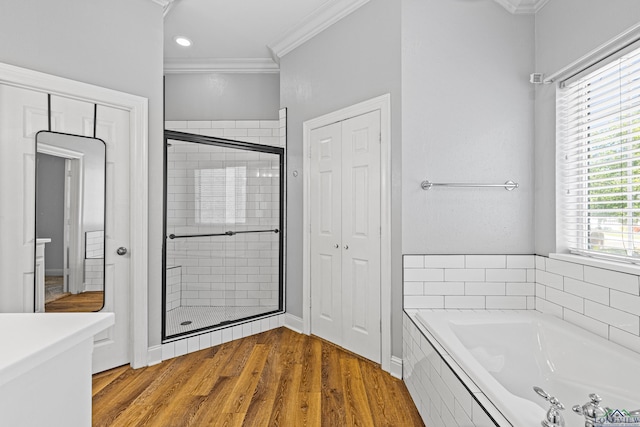 bathroom featuring hardwood / wood-style flooring, crown molding, and plus walk in shower