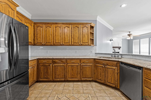 kitchen featuring appliances with stainless steel finishes, decorative backsplash, sink, ceiling fan, and crown molding