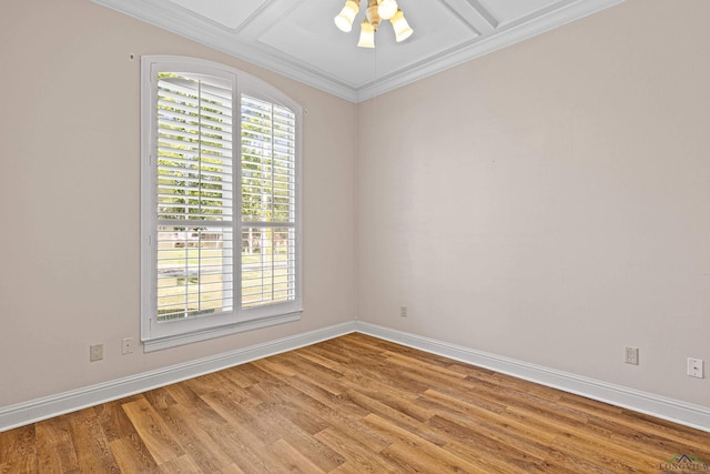 empty room with a healthy amount of sunlight, wood-type flooring, and coffered ceiling