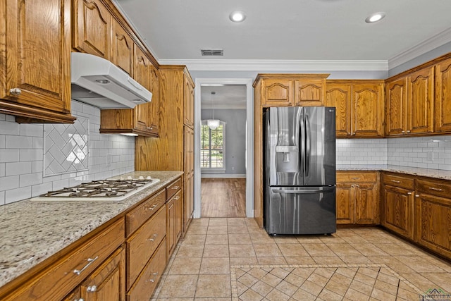 kitchen featuring exhaust hood, decorative backsplash, crown molding, stainless steel fridge with ice dispenser, and white gas stovetop