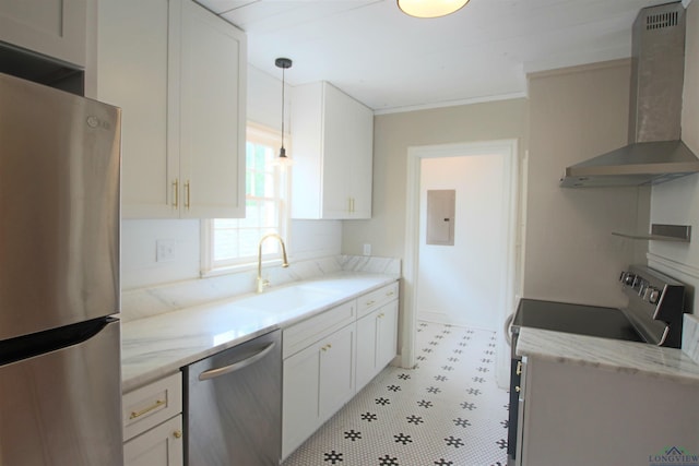 kitchen with white cabinetry, appliances with stainless steel finishes, sink, and wall chimney range hood