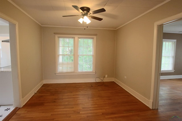 empty room featuring dark wood-type flooring, ceiling fan, and ornamental molding