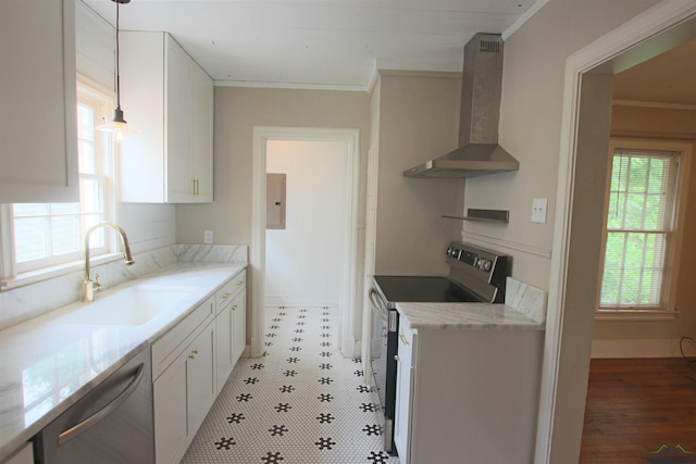 kitchen featuring pendant lighting, wall chimney range hood, white cabinets, and appliances with stainless steel finishes