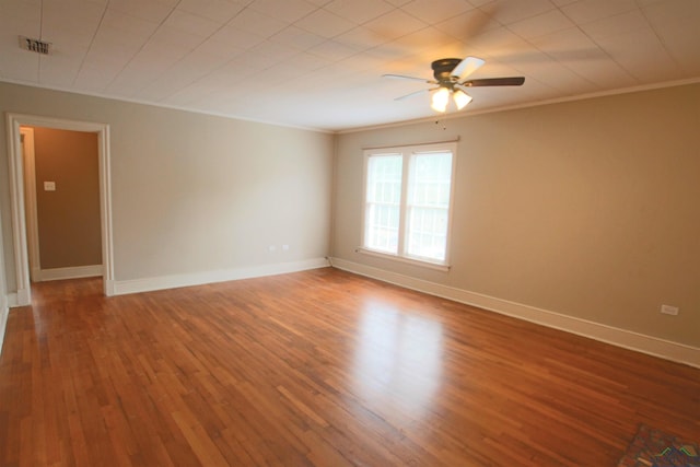 unfurnished room featuring crown molding, wood-type flooring, and ceiling fan