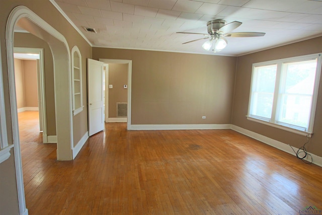 unfurnished room with crown molding, ceiling fan, and light hardwood / wood-style floors