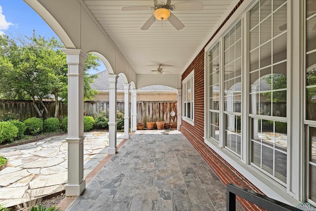 view of patio featuring fence and a ceiling fan