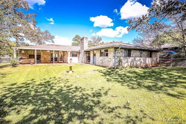 back of property featuring a patio area and a yard