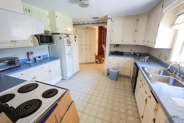 kitchen with white appliances, white cabinetry, and sink