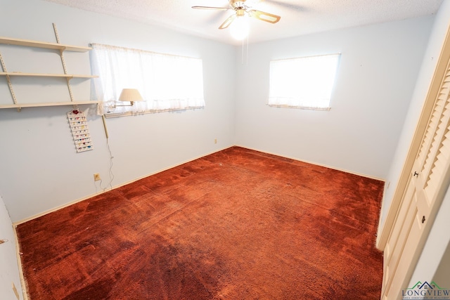 interior space featuring carpet, ceiling fan, and a textured ceiling