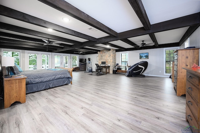 bedroom with beamed ceiling and light wood-type flooring