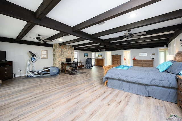 bedroom featuring beamed ceiling and light hardwood / wood-style floors