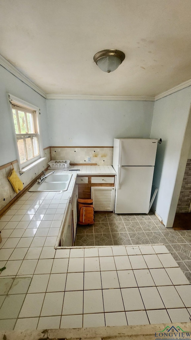 kitchen featuring tile countertops, tile patterned floors, white refrigerator, sink, and stainless steel dishwasher