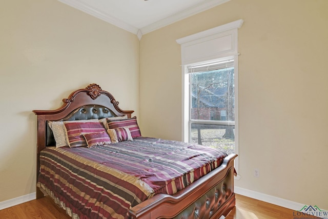 bedroom featuring ornamental molding and hardwood / wood-style floors