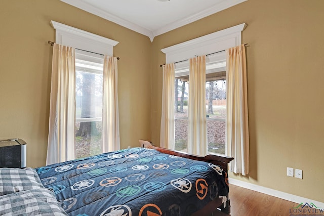 bedroom with wood-type flooring and ornamental molding