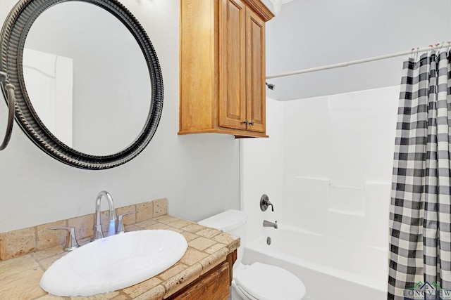 full bathroom featuring sink, toilet, and shower / bath combination with curtain