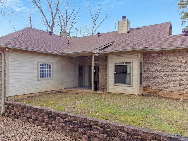 back of house with a lawn