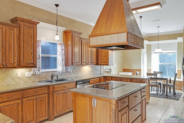 kitchen featuring premium range hood, pendant lighting, a kitchen island, and black electric stovetop