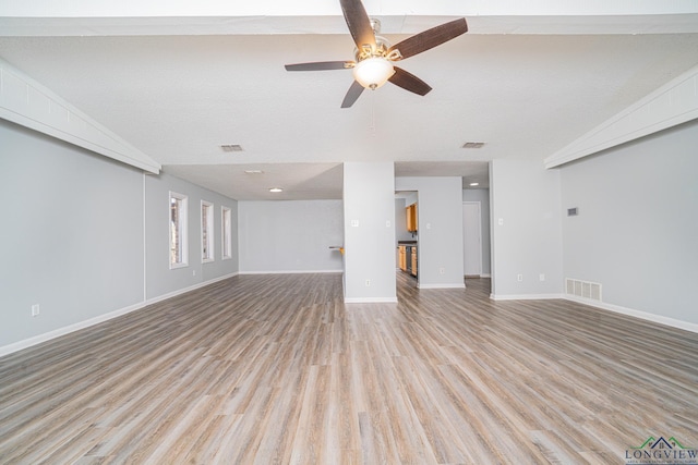 unfurnished living room with ceiling fan, a textured ceiling, light hardwood / wood-style flooring, and lofted ceiling