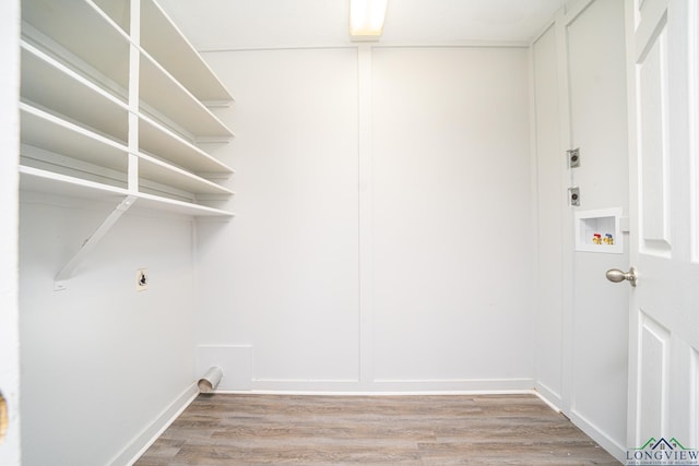 laundry area with electric dryer hookup and hardwood / wood-style floors