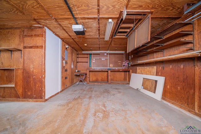 interior space featuring a workshop area and wooden walls