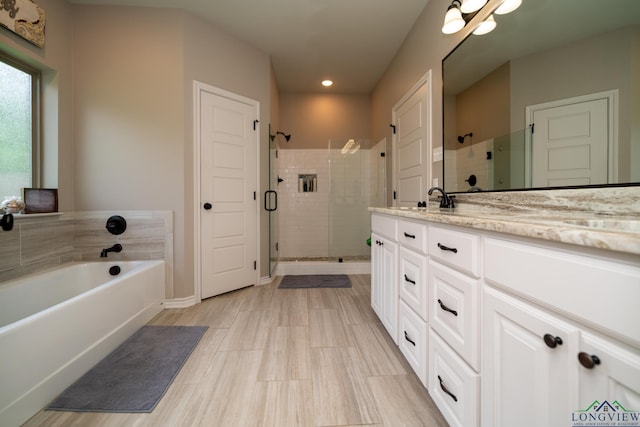 bathroom featuring vanity and separate shower and tub