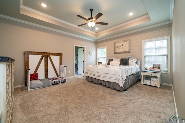 carpeted bedroom with crown molding, a raised ceiling, and ceiling fan