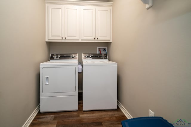 laundry room with cabinets, dark hardwood / wood-style flooring, and washer and clothes dryer