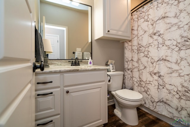 bathroom with walk in shower, vanity, toilet, and wood-type flooring