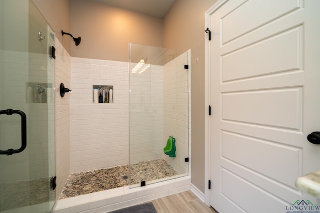 bathroom featuring an enclosed shower and hardwood / wood-style floors