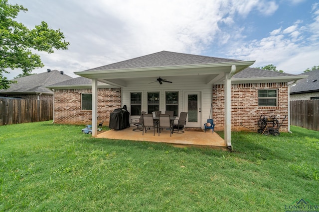 back of property featuring a lawn, ceiling fan, and a patio area