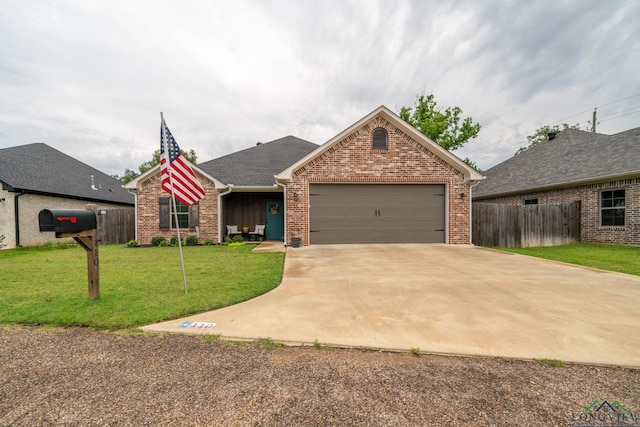 single story home featuring a garage and a front yard