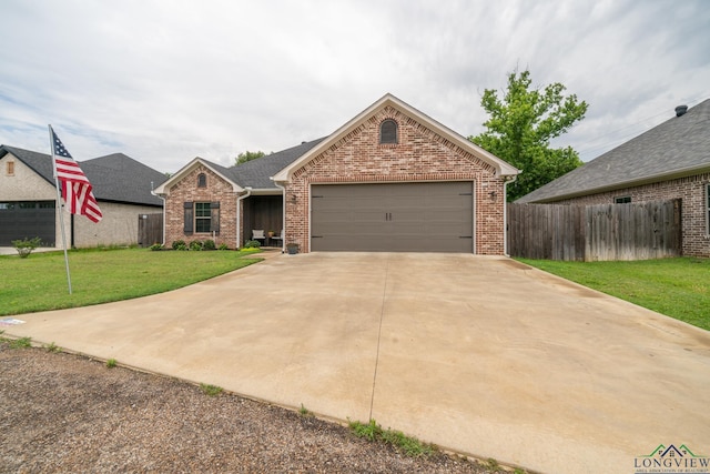 ranch-style house with a garage and a front lawn