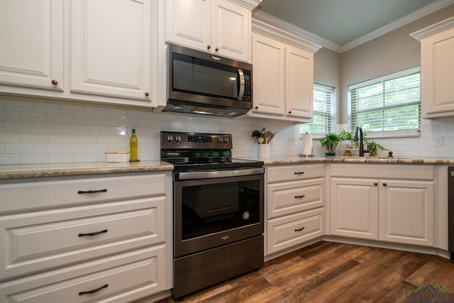 kitchen with sink, white cabinetry, crown molding, stainless steel appliances, and light stone countertops