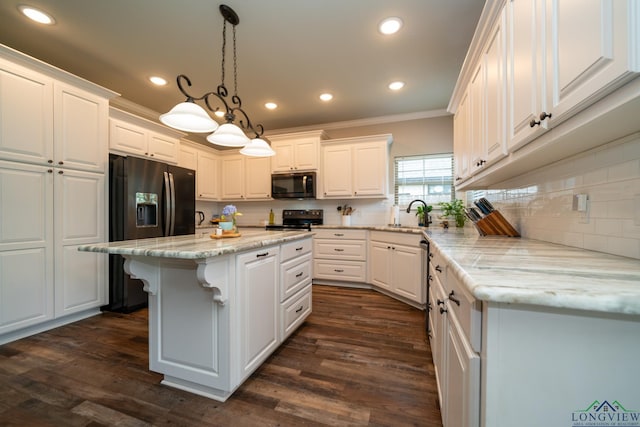 kitchen featuring black appliances, a center island, ornamental molding, pendant lighting, and white cabinets