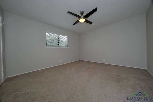 spare room featuring ceiling fan and light colored carpet