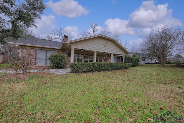 back of house featuring ceiling fan and a lawn