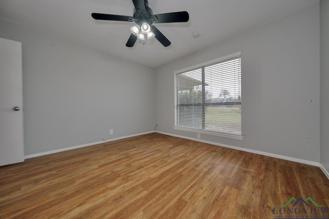 empty room with ceiling fan and light hardwood / wood-style floors