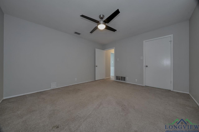 spare room with light carpet and ceiling fan